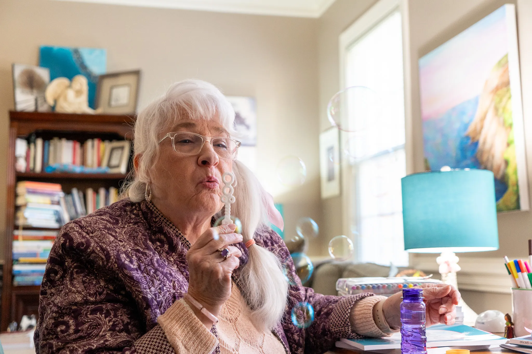 Joan blowing bubbles as a form of breathing execises.