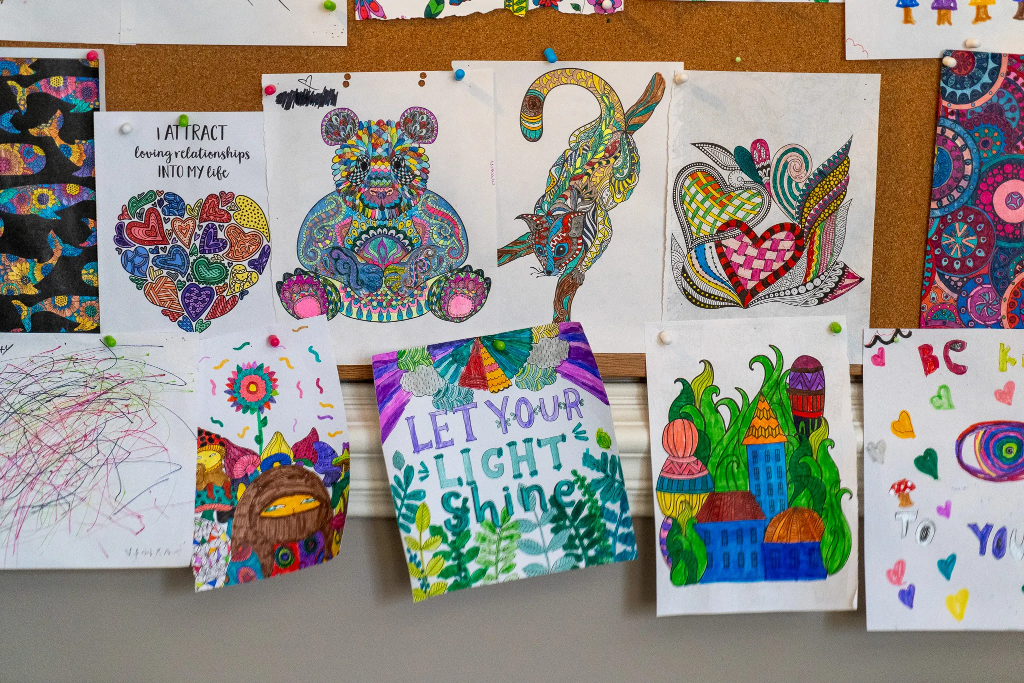 A collection of artworks in Joan's office.